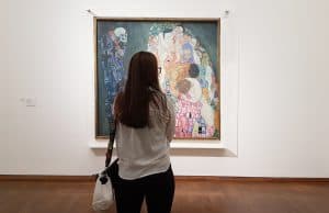 A viewer in front of Gustav Klimt's Life and Death at the Leopold Museum. Photo by Julia Abramova, 2021