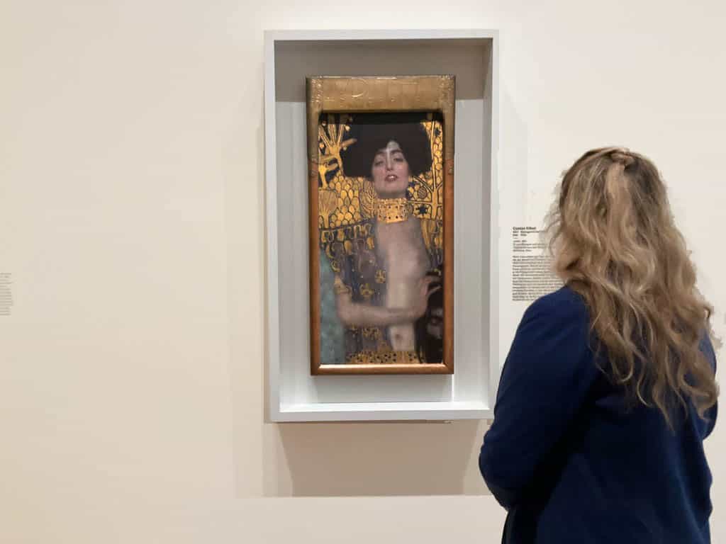 A viewer in front of Gustav Klimt's Judith in the exhibition "Klimt. Inspired by Van Gogh, Rodin, Matisse", 2023. Photo by Julia Abramova